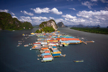 Mesmerizing aerial shot of Koh Panyee, Thailand's floating village. Vibrant stilted structures rise...