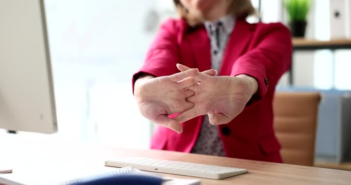 Woman stretches arms in ergonomic office after long hours of work. Comfortable workplace and break