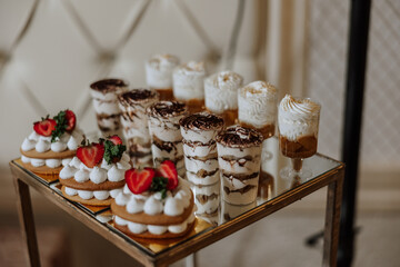 Candy bar at a wedding. Delicious desserts. Beautiful decorations. Fruits. Sweet cakes on your holiday. Birthday. Sweet life.