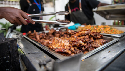 Grilled chicken being served at a party