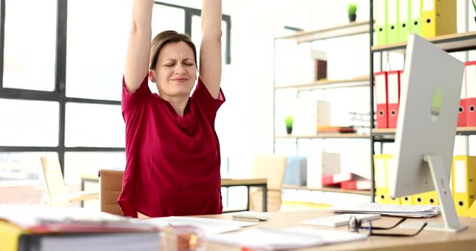 Stress relief woman manager relaxes at workplace and stretches body. Negative effects of sedentary work