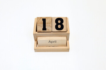18th of April wooden perpetual calendar. Shot close up isolated on a white background