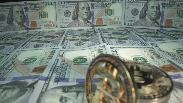 Macro shot of physical bitcoin on 100 dollars bills. Halving bitcoin 2024. Bullrun
