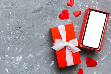 Opened gift box with ribbon and phone on color background, top view. Blank open box packaging mockup , Template for your design - branding mockup