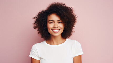 Young happy smiling Latin woman model wearing tshirt standing on color background. Face skin treatment, curly hair care cosmetics makeup, fashion ads. Beauty portrait. White t-shirt mock up template . - obrazy, fototapety, plakaty
