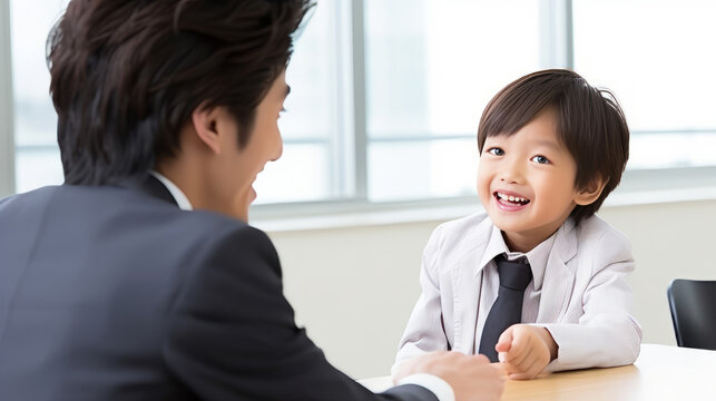 Young Boy in Suit Smiling at Adult in Business Meeting
