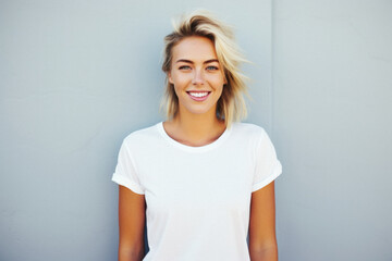 Fototapeta premium Young happy woman, smiling gen z girl model wearing tshirt looking at camera standing on color background. Face skin care cosmetics makeup, fashion ads. Beauty portrait. White t-shirt mock up template