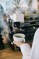 Barista prepares tasty and healthy matcha latte tea..