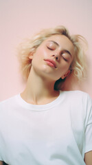 Naklejka premium Young adult pretty woman beauty model wearing white t-shirt posing with eyes closed on color background. Face flawless fresh skin hair care cosmetic treatment makeup products skincare ads .