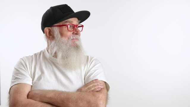 A senior man with a white beard and red glasses gestures to a blank space, perfect for your advertising content. Camera 8K RAW.