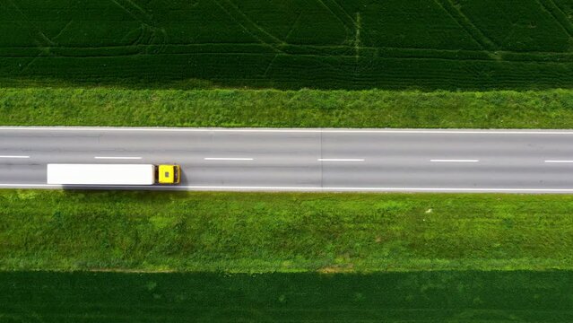 Traffic on country road from drone pov, aerial shot of cars and truck on highway