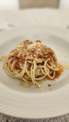 garlic and oil pasta dish on white plate