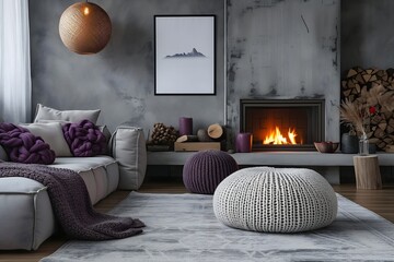Modern home interior featuring a knitted pouf, elegant grey sofas complemented by purple pillows, and a fireplace with a poster frame.