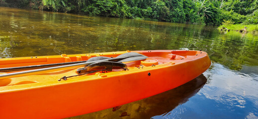 Fototapeta premium red kayak on a day in a tropical forest in Brazil, amidst nature and lots of greenery