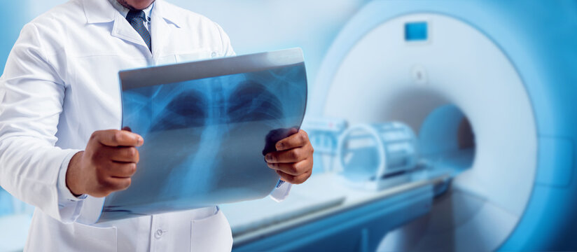 Doctor looking MRI picture. Medical equipment. Light background.