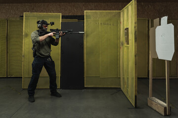 A man engages cqb tactical rifle shooting at a shooting range.