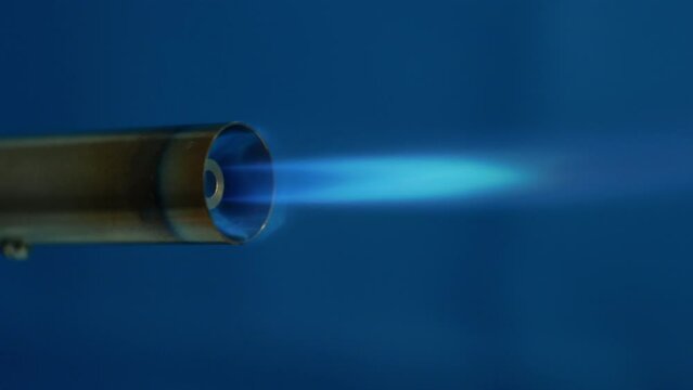 A gas recative jet of blue flame burns intensely. Prototype of a tiny jet engine powered by liquefied gas