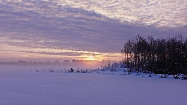 Foggy sunset in winter snow