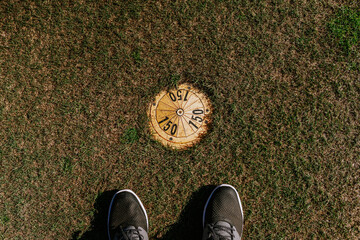 Sotogrante, Spain - January 25, 2024 - Golfer's feet beside a yardage marker on grass indicating...