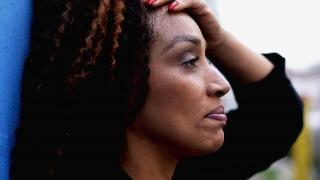 One Anxious Black Woman In 50s Feeling Overwhelmed By Life Feeling Stress And Worry During Difficult Times, Tight Close-up Face Of Pensive Contemplative Expression