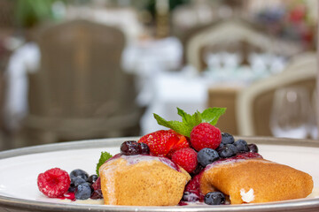 Pancakes with fresh berries on a plate. Selective focus.