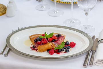Pancakes with raspberries and blueberries on a plate