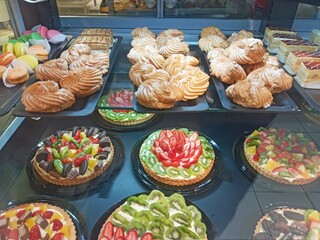 different cakes are on display in a supermarket