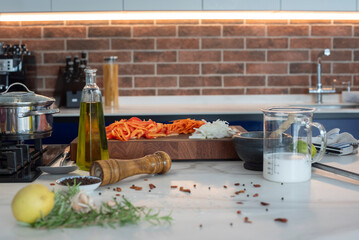 an island kitchen with cut vegetables and olive oil