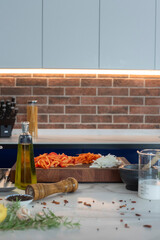 an island kitchen with cut vegetables and olive oil