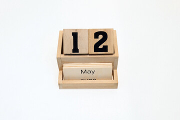 12h of May wooden perpetual calendar. Shot close up isolated on a white background