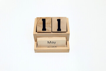 11th of May wooden perpetual calendar. Shot close up isolated on a white background