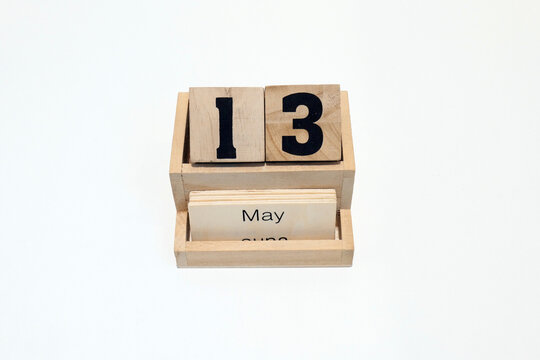 13h of May wooden perpetual calendar. Shot close up isolated on a white background