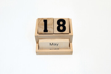 18h of May wooden perpetual calendar. Shot close up isolated on a white background