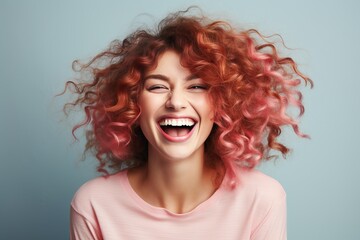 Cheerful young woman with vibrant pink hair smiling and making eye contact with copy space