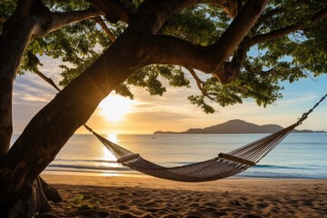 A hammock sways on the beach at sunrise, a tranquil spot for relaxation and serenity.
