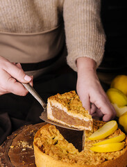woman cut off a piece grated cake tart with lemon curd