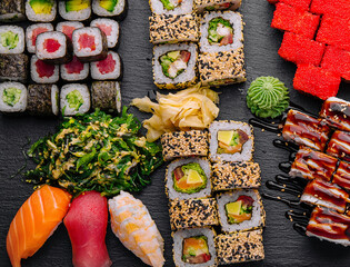 Large sushi set, shot from the top on a black background