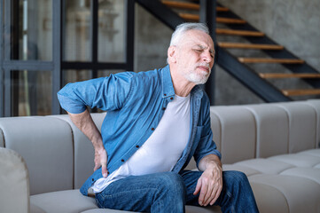 Middle aged man feeling unwell and suffering from chronic backache