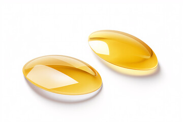 Isolated golden-hued collagen hydrogel eye patches on a white backdrop.