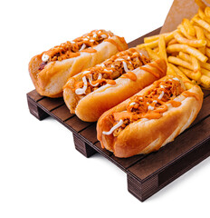 Hot dogs and fried potatoes on wooden board