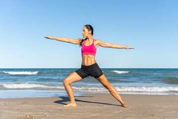 Fototapeta na wymiar Middle aged woman exercising on the beach