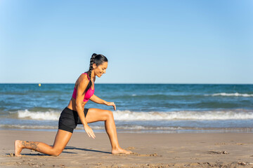 Fototapeta na wymiar Middle aged woman exercising on the beach