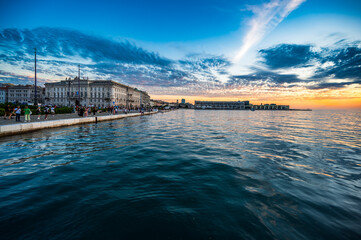 Dusk and night in Trieste. Between historic buildings and the sea.
