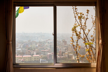 View of Kathmandu from hotel window through urban haze with lot of low rise buildings, cityscape...
