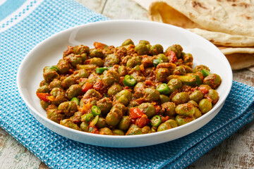 Peas masala orspicy matar green bean with tomato and green chilli served in dish isolated on table top view of arabic food
