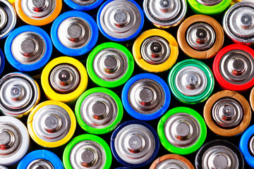 Energy abstract background of colorful batteries.Old used batteries ready for recycling.Used batteries from different manufacturers, waste, collection and recycling,Alkaline battery aa size.