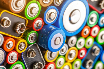Energy abstract background of colorful batteries.Old used batteries ready for recycling.Used...