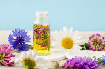 Small bottle with cosmetic oil. Aromatherapy, homemade beauty treatment and herbal medicine ingredients.