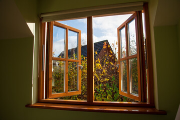 Open Double glazed wooden window in the autumn 