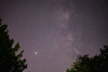 Planets Jupiter and Saturn on summer night sky with milky way galaxy shining trough millions of stars 